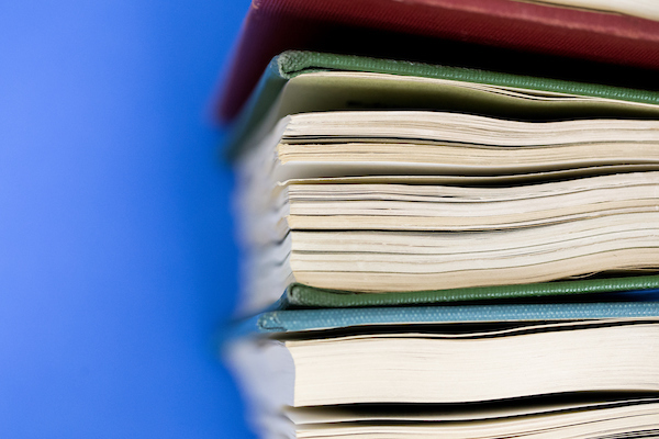 stack of books with blue background
